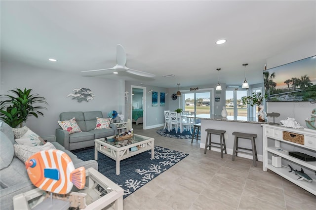 living room with light tile patterned floors and ceiling fan