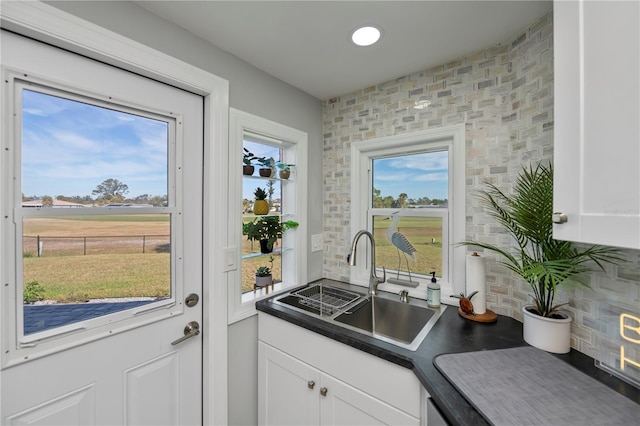 kitchen with white cabinetry and sink