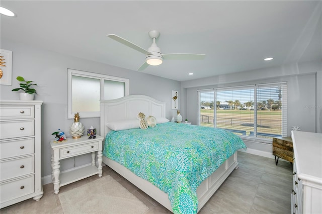 bedroom with ceiling fan and light tile patterned floors