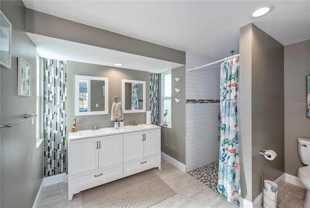 bathroom featuring vanity, tile patterned flooring, a shower with curtain, and toilet