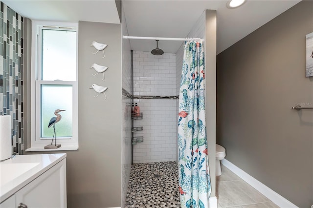 bathroom with vanity, curtained shower, tile patterned floors, and toilet