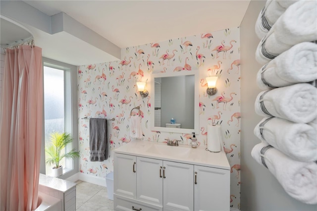 bathroom with a tub to relax in, tile patterned floors, and vanity