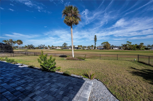 view of yard with a rural view and a patio