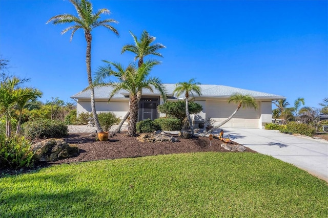 view of front of home featuring a garage and a front lawn