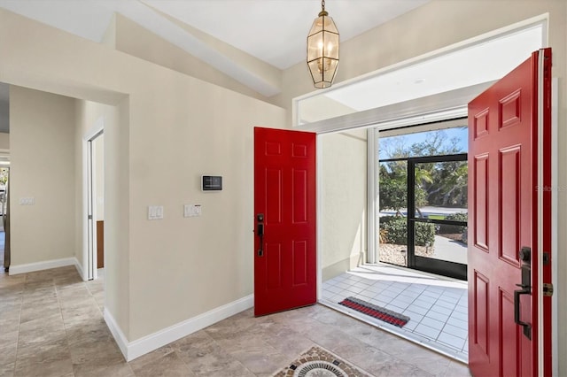 entryway with a chandelier