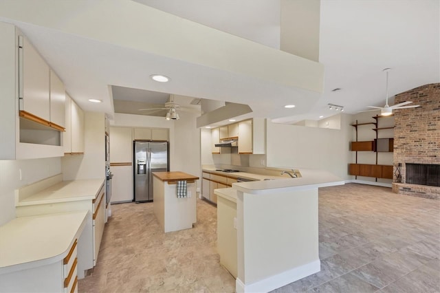 kitchen featuring a kitchen island, white cabinetry, butcher block counters, ceiling fan, and stainless steel fridge with ice dispenser