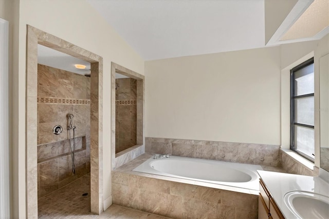 bathroom featuring vanity, lofted ceiling, and separate shower and tub