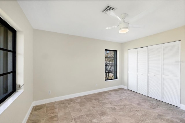 unfurnished bedroom featuring ceiling fan and a closet