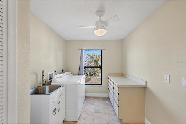 laundry area with sink, cabinets, washer and dryer, and ceiling fan