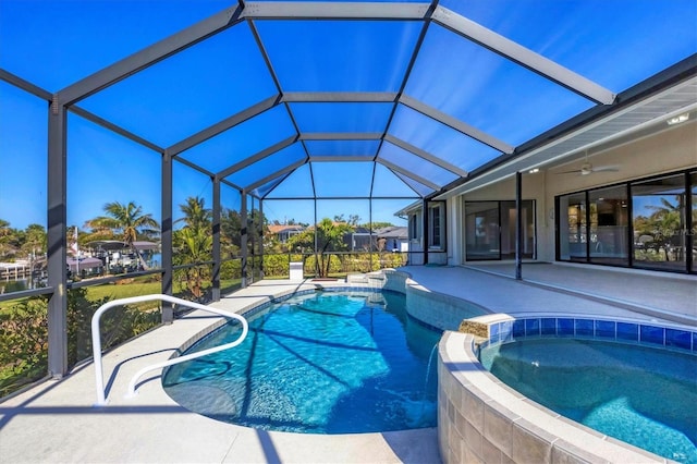 view of pool with an in ground hot tub, a lanai, ceiling fan, and a patio area