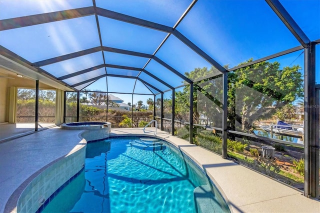 view of swimming pool featuring an in ground hot tub, a water view, glass enclosure, and a patio area