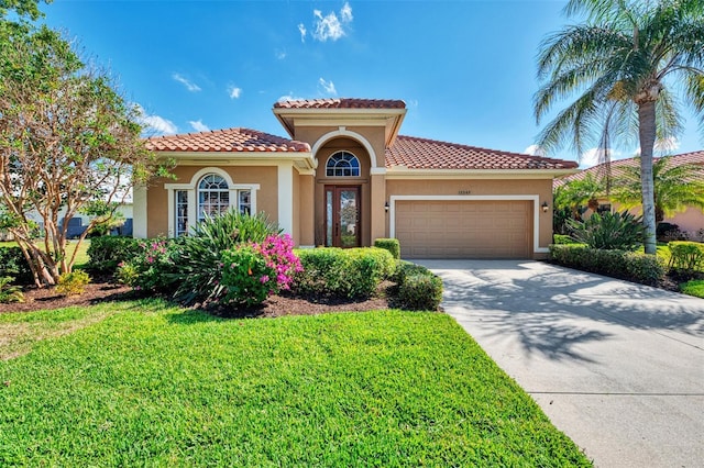 mediterranean / spanish home featuring a garage and a front lawn