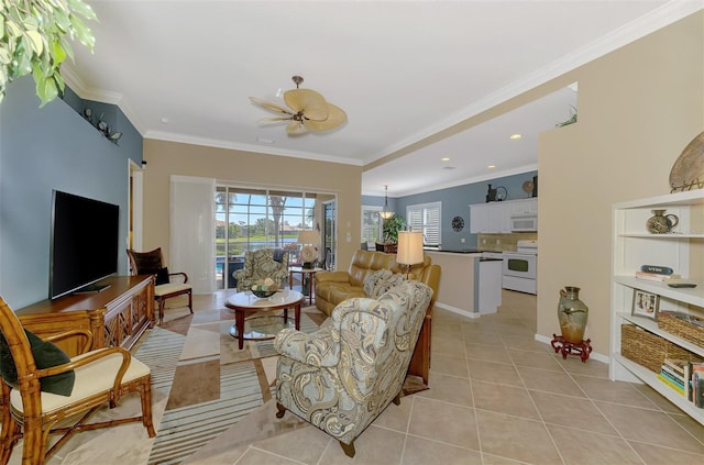 living room featuring light tile patterned floors, ornamental molding, and ceiling fan