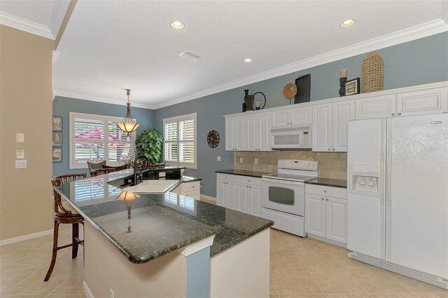 kitchen with a kitchen island with sink, sink, white appliances, and white cabinets