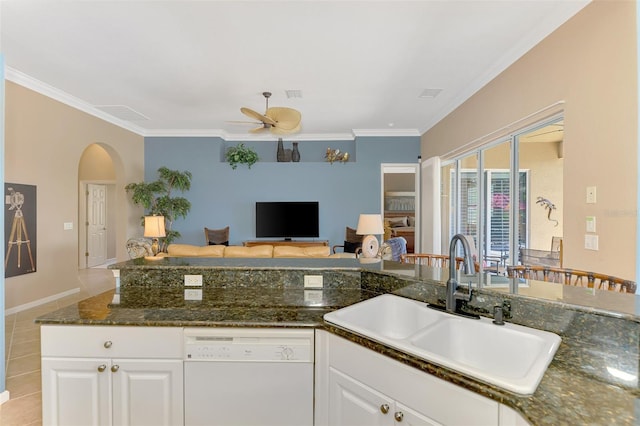 kitchen featuring dark stone counters, white dishwasher, sink, and white cabinets