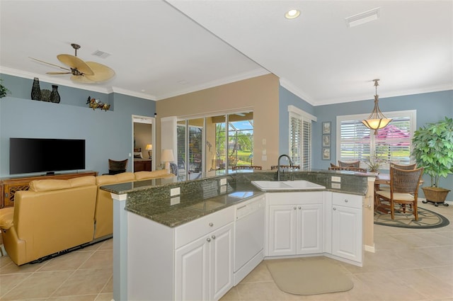 kitchen with sink, dishwasher, an island with sink, and white cabinets