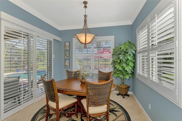 tiled dining area featuring crown molding