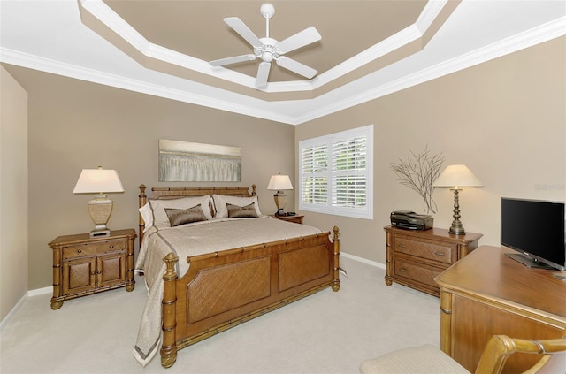 carpeted bedroom featuring crown molding, ceiling fan, and a raised ceiling