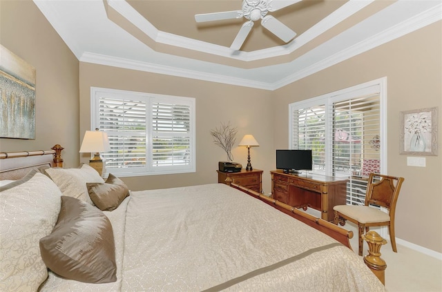 carpeted bedroom featuring ceiling fan, ornamental molding, and a raised ceiling