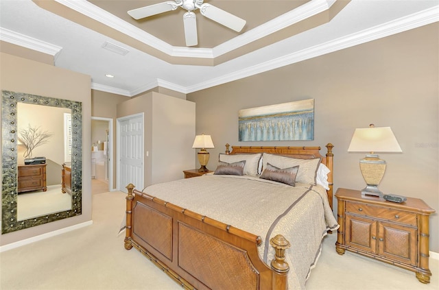 bedroom featuring connected bathroom, ornamental molding, a raised ceiling, light colored carpet, and a closet