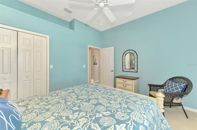 carpeted bedroom with ceiling fan and a closet