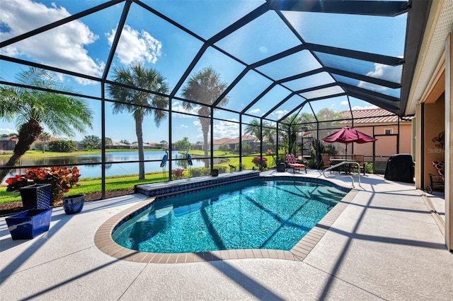 view of swimming pool featuring a patio, a water view, and glass enclosure