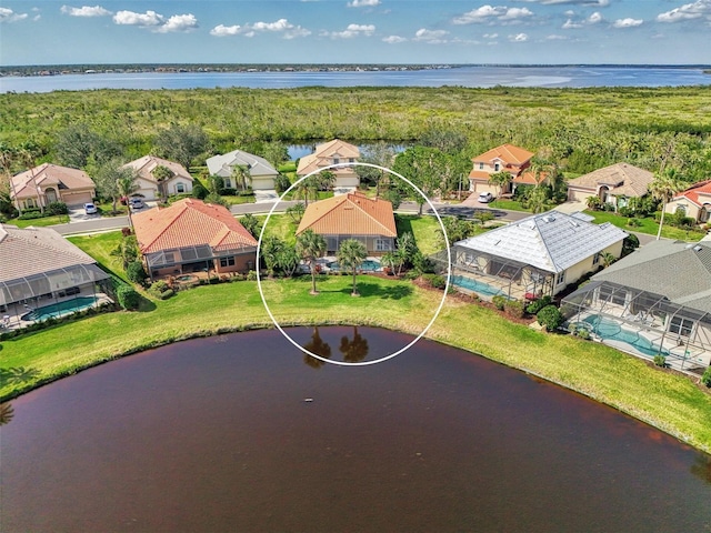 birds eye view of property with a water view