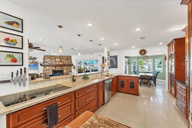 kitchen featuring sink, light tile patterned floors, stainless steel dishwasher, pendant lighting, and a fireplace