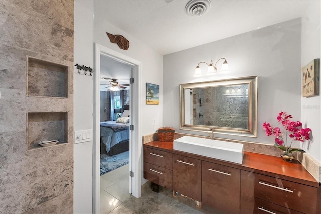 bathroom featuring vanity, ceiling fan, tile patterned floors, and a fireplace