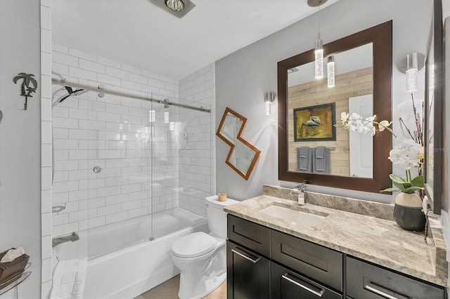 full bathroom featuring bath / shower combo with glass door, vanity, and toilet