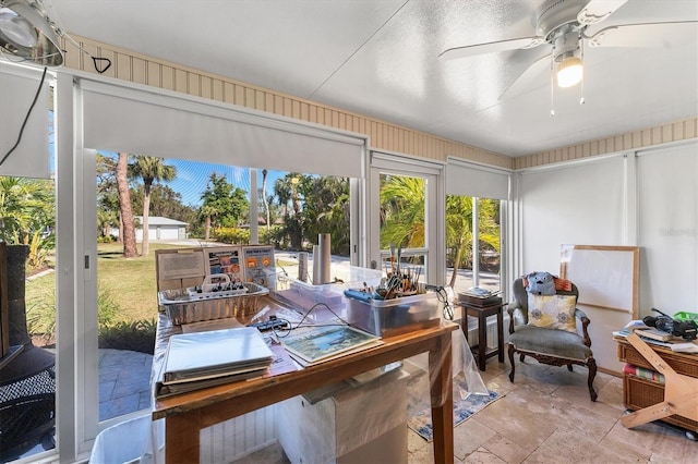 sunroom featuring ceiling fan