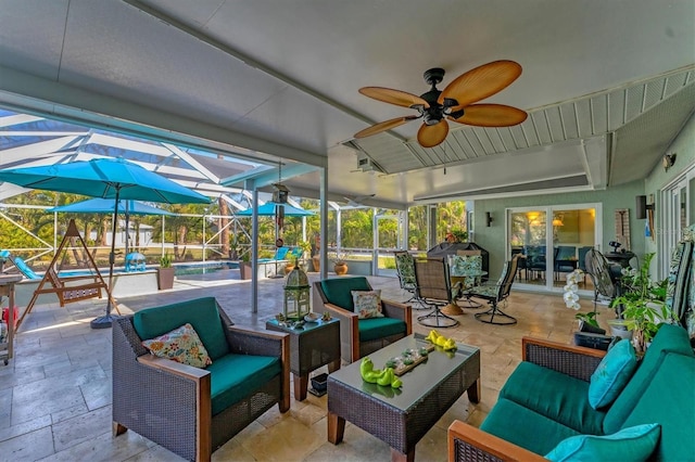 view of patio / terrace with an outdoor hangout area, ceiling fan, and glass enclosure