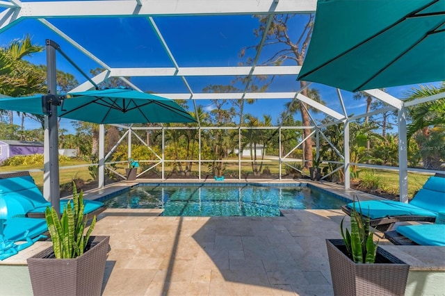 view of swimming pool featuring a lanai and a patio area