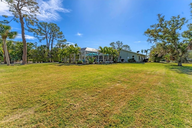 view of yard featuring glass enclosure