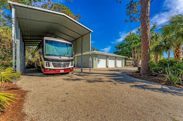 view of vehicle parking featuring a carport and a garage