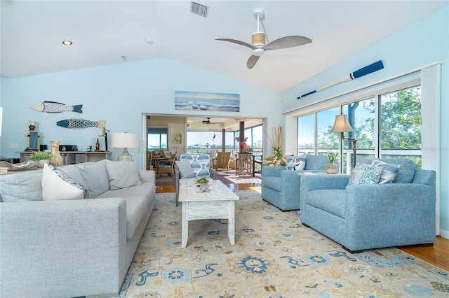 living room featuring ceiling fan, high vaulted ceiling, and light wood-type flooring