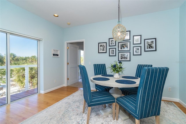 dining room featuring plenty of natural light and light hardwood / wood-style flooring