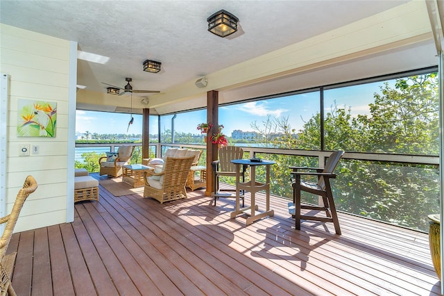 exterior space with a water view and ceiling fan