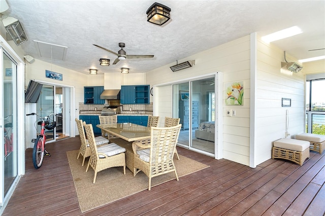 dining room featuring dark hardwood / wood-style floors, a textured ceiling, and ceiling fan