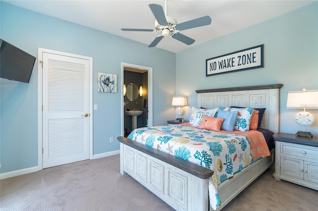 carpeted bedroom with ceiling fan and ensuite bathroom