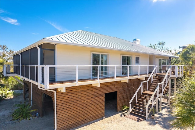 rear view of house featuring a sunroom