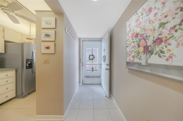 hall featuring light tile patterned floors