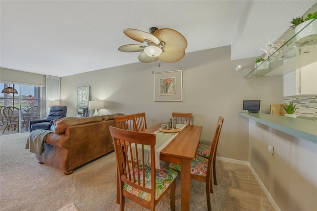 carpeted dining space featuring ceiling fan