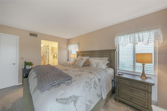 carpeted bedroom with connected bathroom