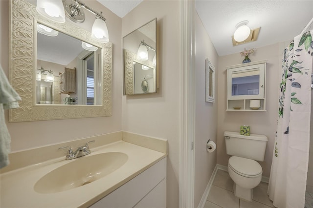 bathroom with vanity, toilet, and tile patterned flooring