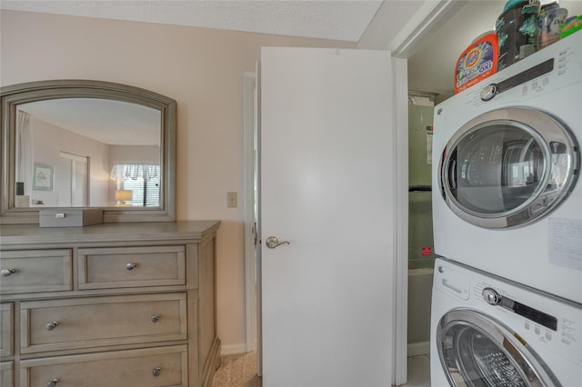 laundry room featuring stacked washer and dryer and light colored carpet