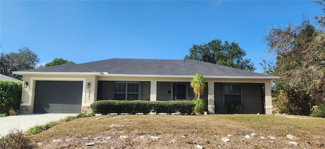 single story home with a garage and a front yard