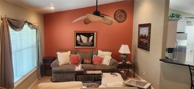 living room with ceiling fan and a wealth of natural light