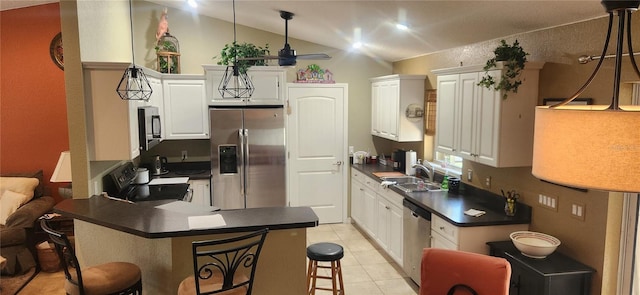 kitchen with sink, a kitchen breakfast bar, white cabinets, and appliances with stainless steel finishes