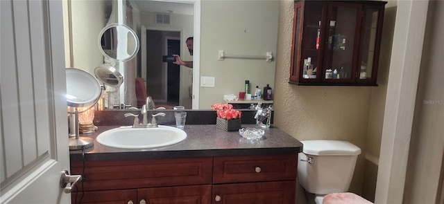 bathroom featuring vanity and toilet